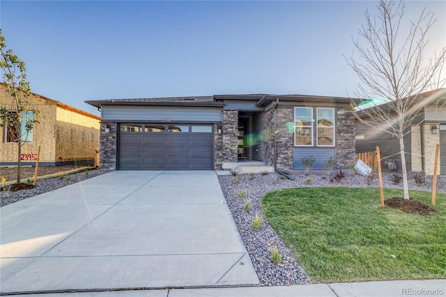 prairie-style house with a garage and a front yard