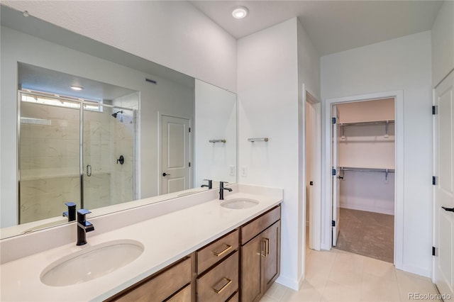 bathroom featuring vanity, a shower with shower door, and tile patterned flooring