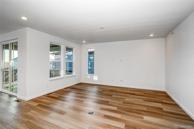 unfurnished room with light hardwood / wood-style flooring