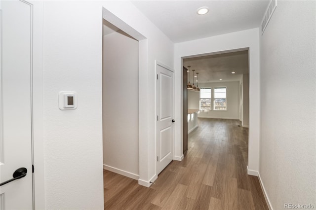 hallway with light hardwood / wood-style flooring