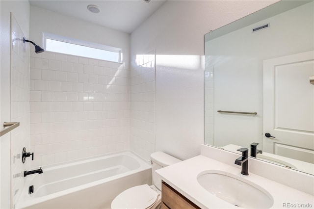 full bathroom featuring toilet, tiled shower / bath combo, and vanity