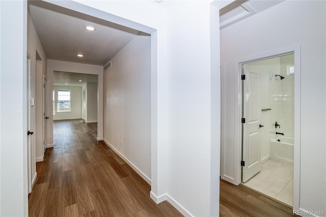 hall with hardwood / wood-style flooring