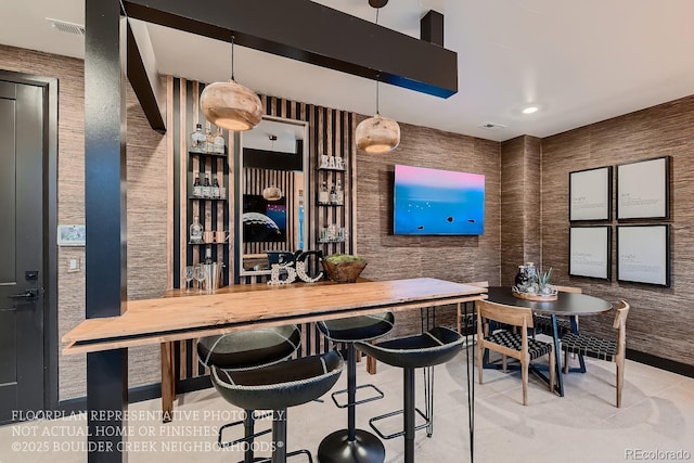 bar featuring pendant lighting and wooden counters