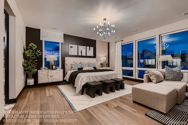 bedroom featuring an inviting chandelier and light wood-type flooring