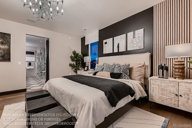 bedroom featuring ensuite bath, hardwood / wood-style floors, and a notable chandelier