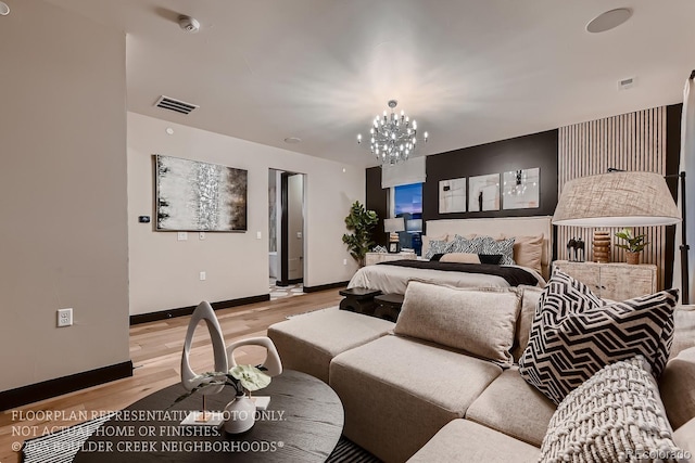 bedroom featuring an inviting chandelier and light hardwood / wood-style floors