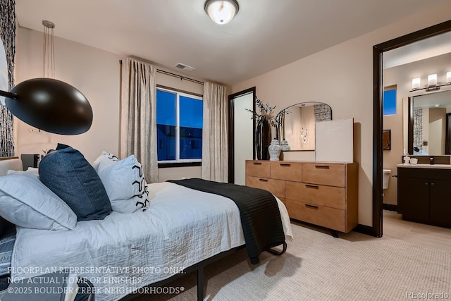 bedroom featuring sink and connected bathroom