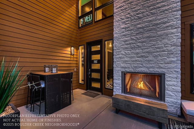 property entrance featuring an outdoor stone fireplace