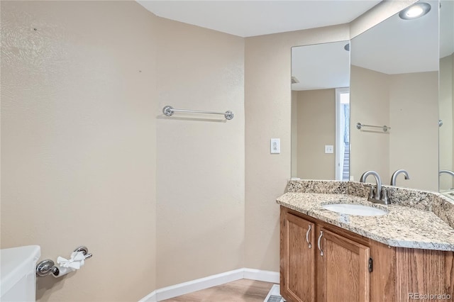 bathroom featuring vanity and toilet