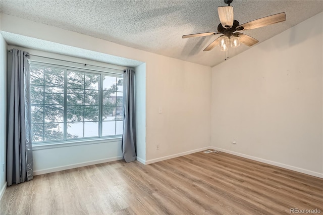 unfurnished room featuring a textured ceiling, light hardwood / wood-style floors, ceiling fan, and a healthy amount of sunlight