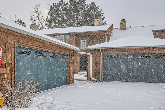 snow covered gate with a garage