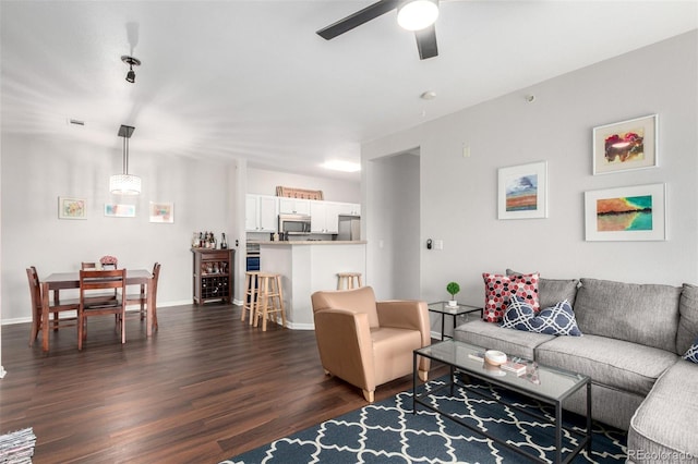 4451 S Ammons St Unit 5-307, Littleton, CO 80123 - living area featuring baseboards, ceiling fan, and dark wood-style floors