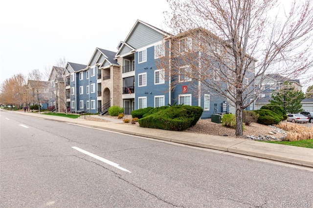 4451 S Ammons St Unit 5-307, Littleton, CO 80123 - view of road featuring a residential view, sidewalks, and curbs
