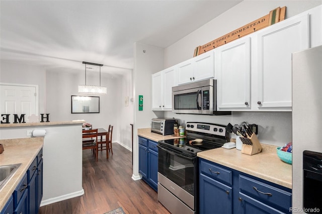 4451 S Ammons St Unit 5-307, Littleton, CO 80123 - kitchen with blue cabinets, appliances with stainless steel finishes, light countertops, white cabinetry, and dark wood-type flooring