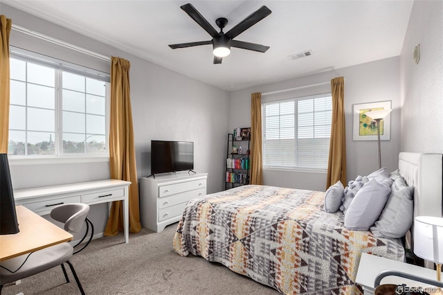 4451 S Ammons St Unit 5-307, Littleton, CO 80123 - bedroom featuring carpet flooring, ceiling fan, visible vents, and multiple windows