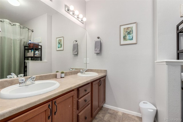 4451 S Ammons St Unit 5-307, Littleton, CO 80123 - bathroom with a sink, baseboards, and double vanity
