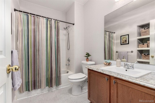 4451 S Ammons St Unit 5-307, Littleton, CO 80123 - bathroom featuring toilet, tile patterned floors, shower / bath combo, and vanity