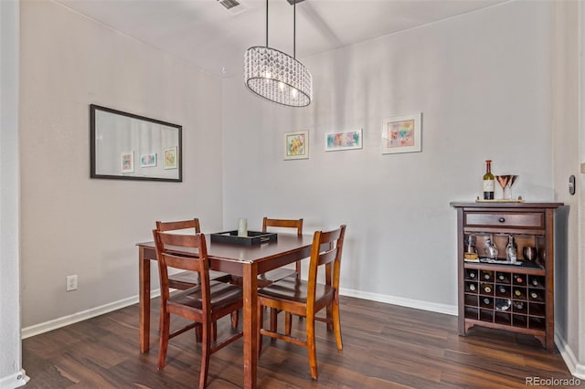4451 S Ammons St Unit 5-307, Littleton, CO 80123 - dining area featuring dark wood-type flooring and a chandelier