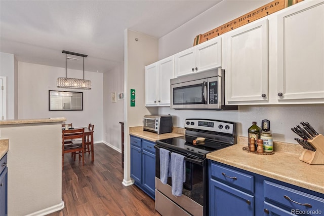 4451 S Ammons St Unit 5-307, Littleton, CO 80123 - kitchen with stainless steel appliances, blue cabinets, light countertops, and white cabinets