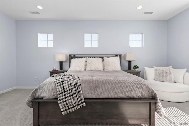 carpeted bedroom featuring recessed lighting, multiple windows, and visible vents