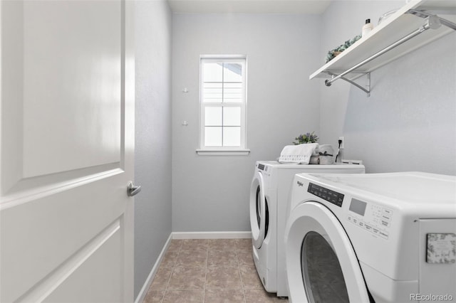 laundry room with laundry area, washing machine and dryer, light tile patterned floors, and baseboards