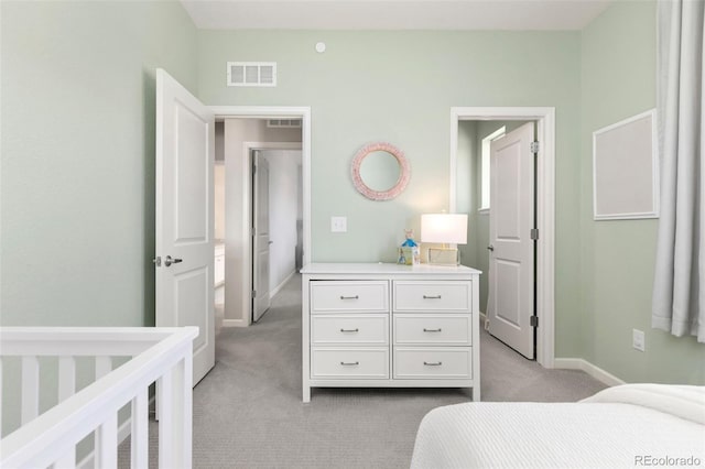 bedroom featuring light carpet, visible vents, and baseboards