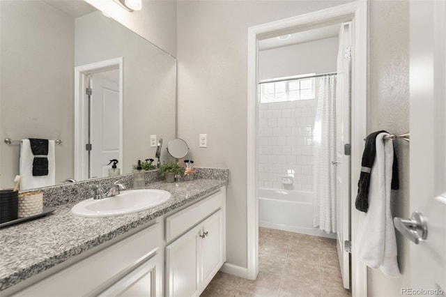 full bathroom with tile patterned floors, baseboards, and vanity