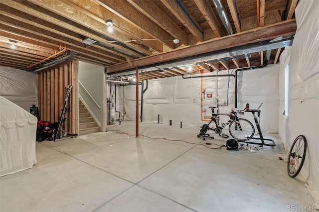 unfinished below grade area with stairway and gas water heater