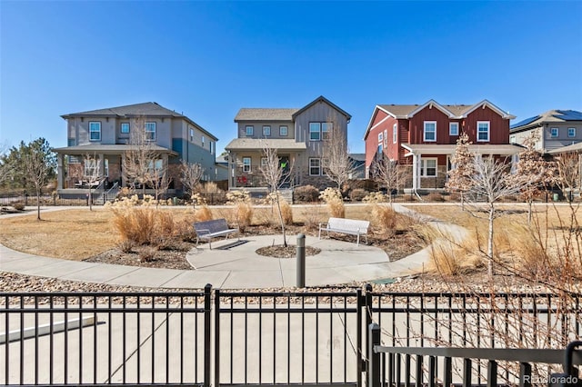 view of front of house with a fenced front yard, a residential view, and board and batten siding