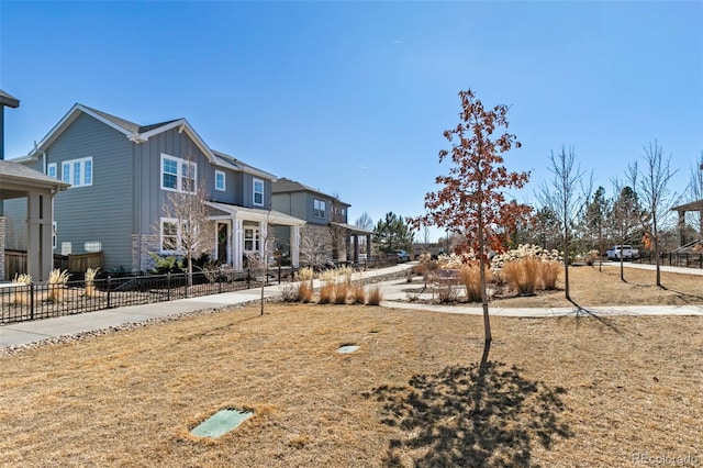 view of front of home with fence and board and batten siding