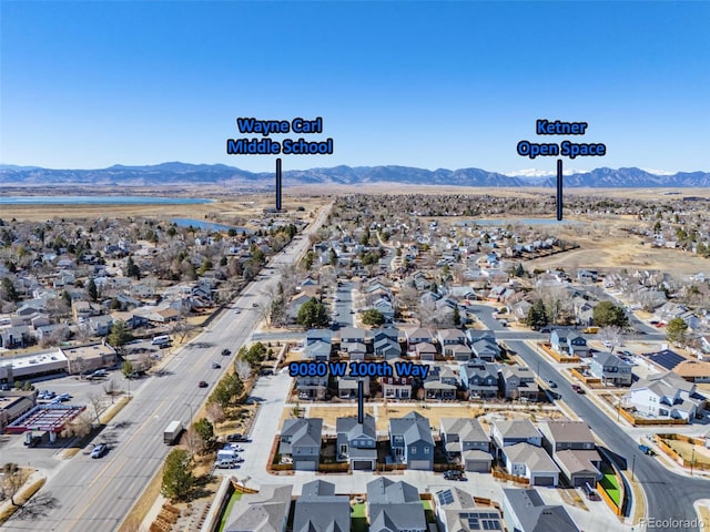 drone / aerial view featuring a residential view and a mountain view