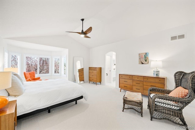 bedroom with arched walkways, light colored carpet, a ceiling fan, visible vents, and lofted ceiling