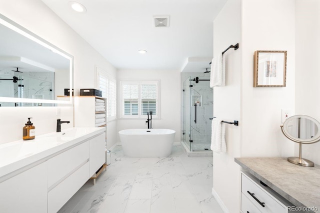 bathroom with a freestanding tub, recessed lighting, marble finish floor, a stall shower, and baseboards