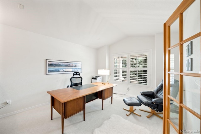 office space with baseboards, light carpet, and lofted ceiling