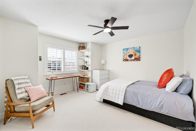 bedroom with light carpet, ceiling fan, baseboards, and visible vents