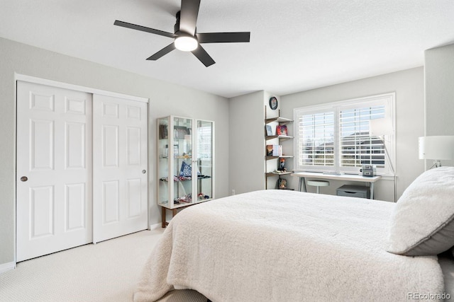 carpeted bedroom with a closet and a ceiling fan