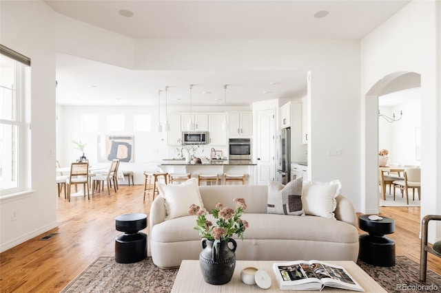 living room with sink and light hardwood / wood-style flooring