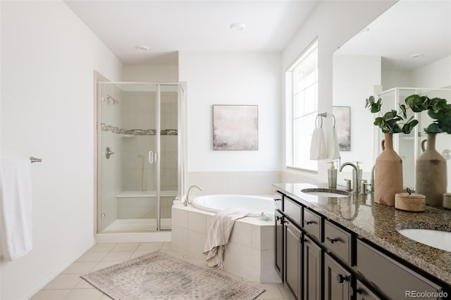 bathroom featuring tile patterned flooring, vanity, and shower with separate bathtub