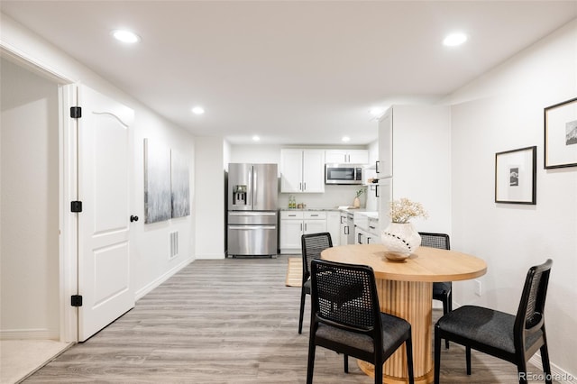 dining area with light hardwood / wood-style floors