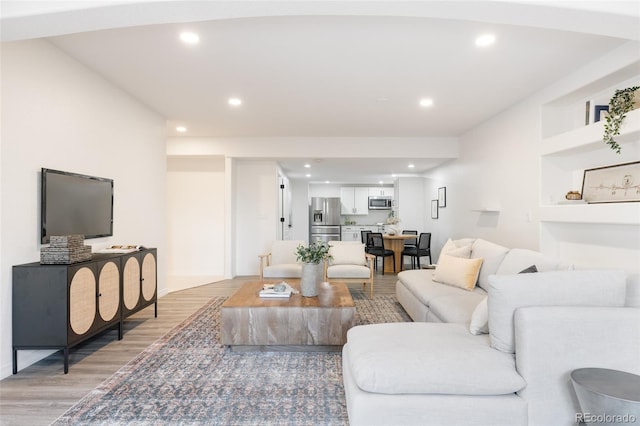 living room featuring hardwood / wood-style flooring and built in features