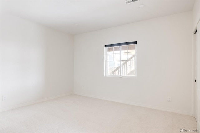 empty room featuring light colored carpet