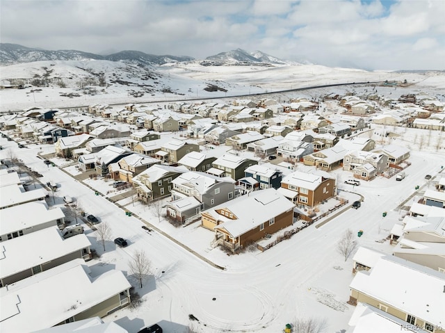 snowy aerial view with a mountain view