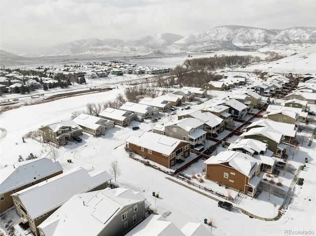 snowy aerial view with a mountain view