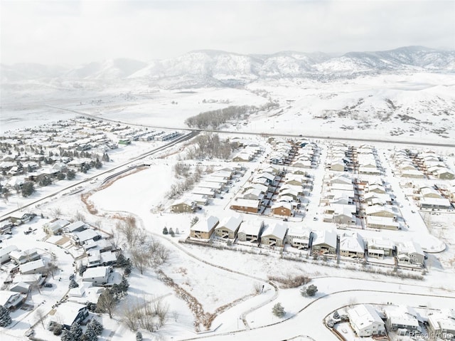 snowy aerial view featuring a mountain view