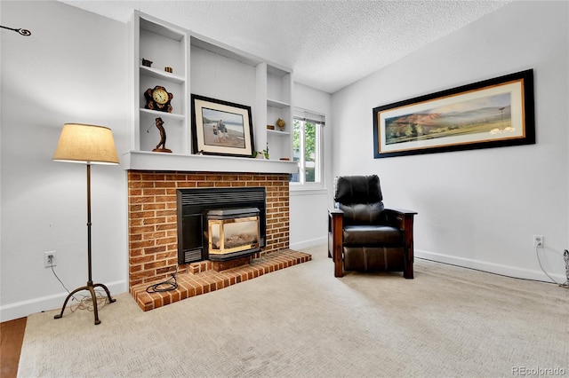 living area featuring baseboards, a textured ceiling, and carpet floors