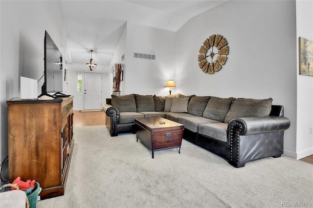 living area with lofted ceiling, baseboards, and wood finished floors