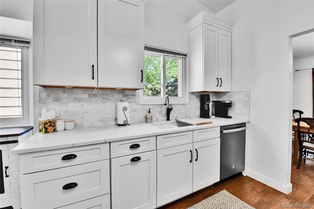 kitchen with dishwasher, a sink, white cabinets, backsplash, and dark wood-style floors