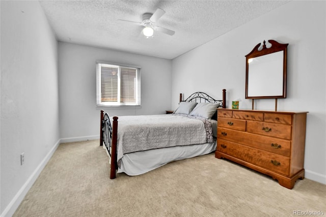 bedroom featuring a textured ceiling, carpet, baseboards, and a ceiling fan