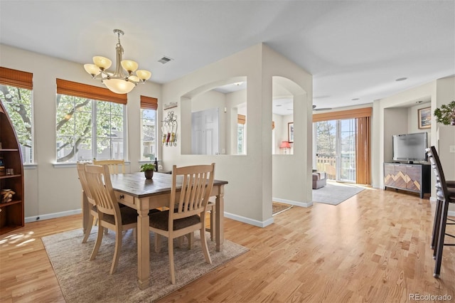 17808 E 104th Pl Unit C, Commerce City, CO 80022 - dining room with a chandelier, light wood-style floors, and arched walkways