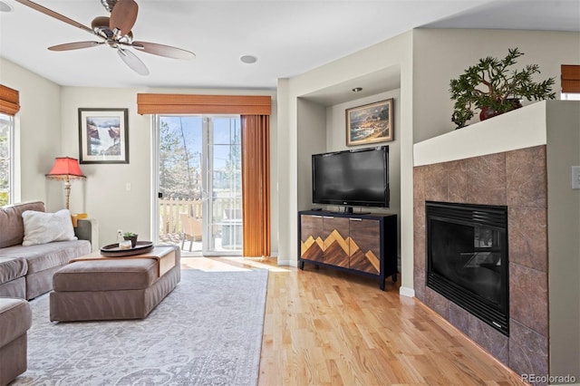 17808 E 104th Pl Unit C, Commerce City, CO 80022 - living area featuring light wood finished floors, ceiling fan, and a fireplace